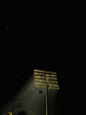 High mast lights illuminating a large outdoor area at night.