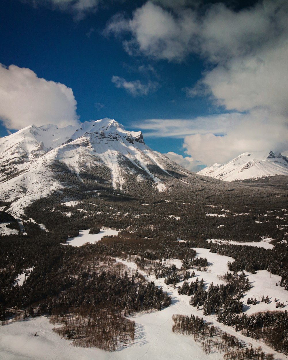 an aerial view of a snowy mountain range