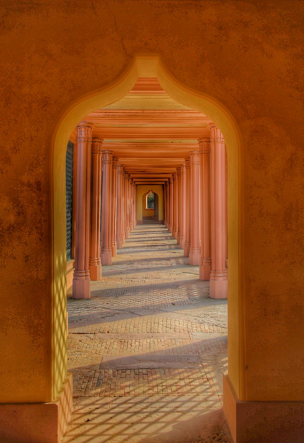 an archway leading into a building with columns