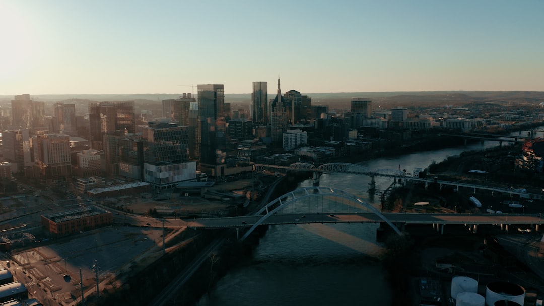 an aerial view of a city with a bridge, Still from drone shot of downtown Nashville. Full video available at youtube.com
