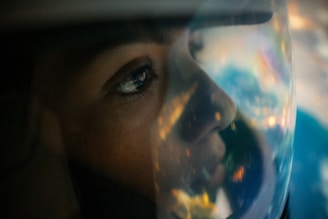 A close-up of a rider's helmet reflecting a vibrant landscape.