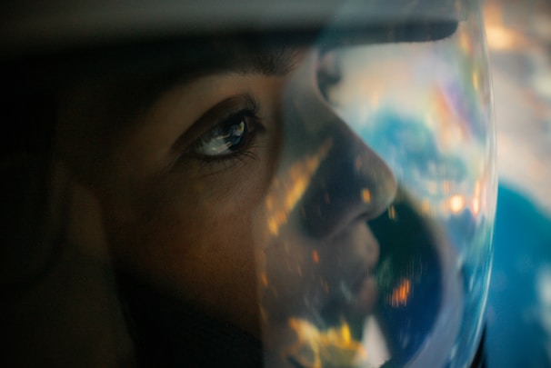 A close-up of a rider's helmet reflecting a vibrant landscape.