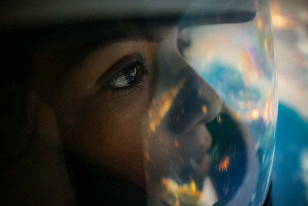 a close up of a person's face with a bubble in front of them