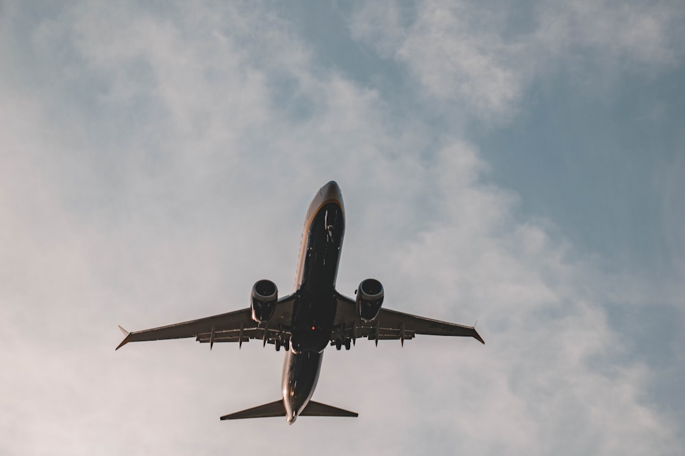 a large jetliner flying through a cloudy blue sky