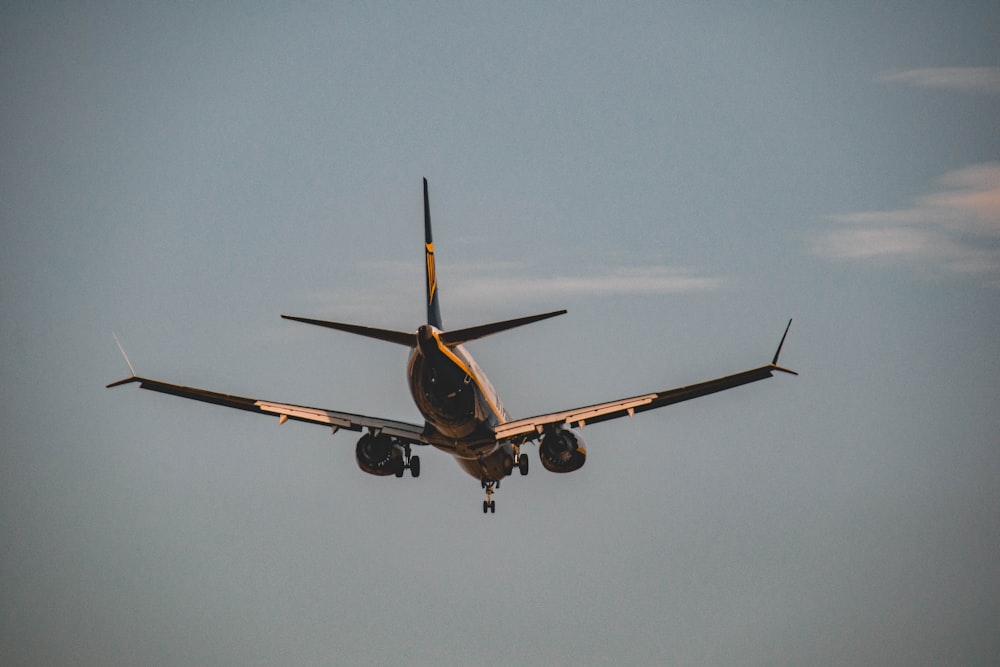 a large jetliner flying through a blue sky