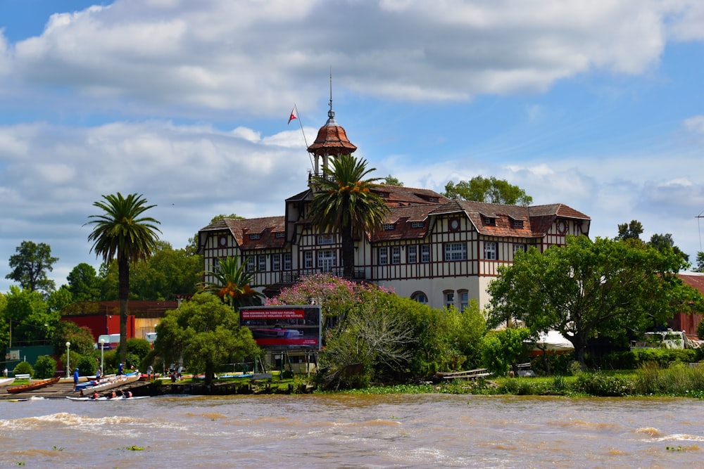 a large building sitting on the side of a river