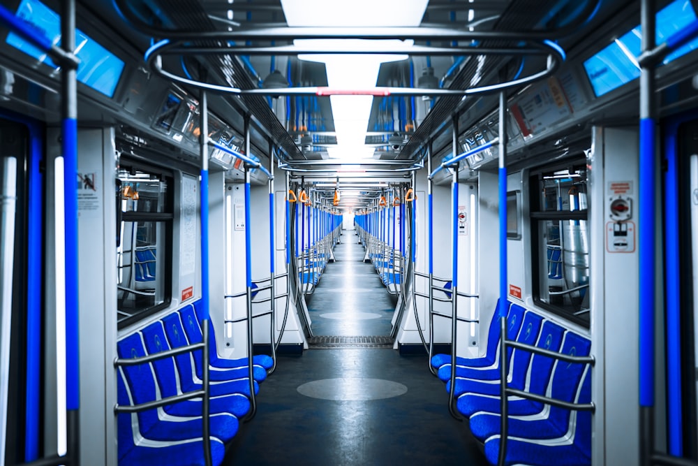 une voiture de train avec des sièges bleus et un plafond
