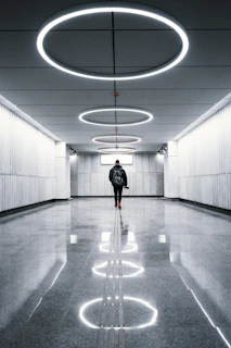 a man is walking down a long hallway