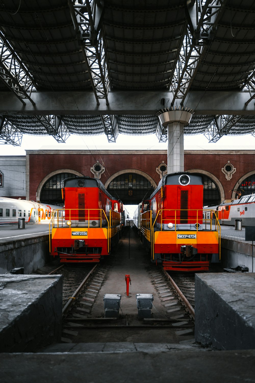 a couple of trains that are sitting in a train station