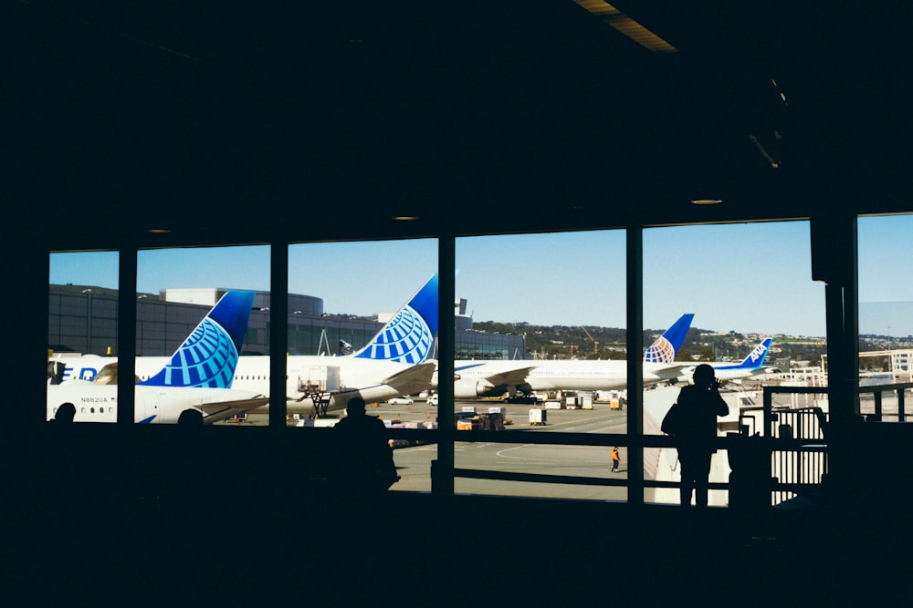 a couple of people standing in front of a window