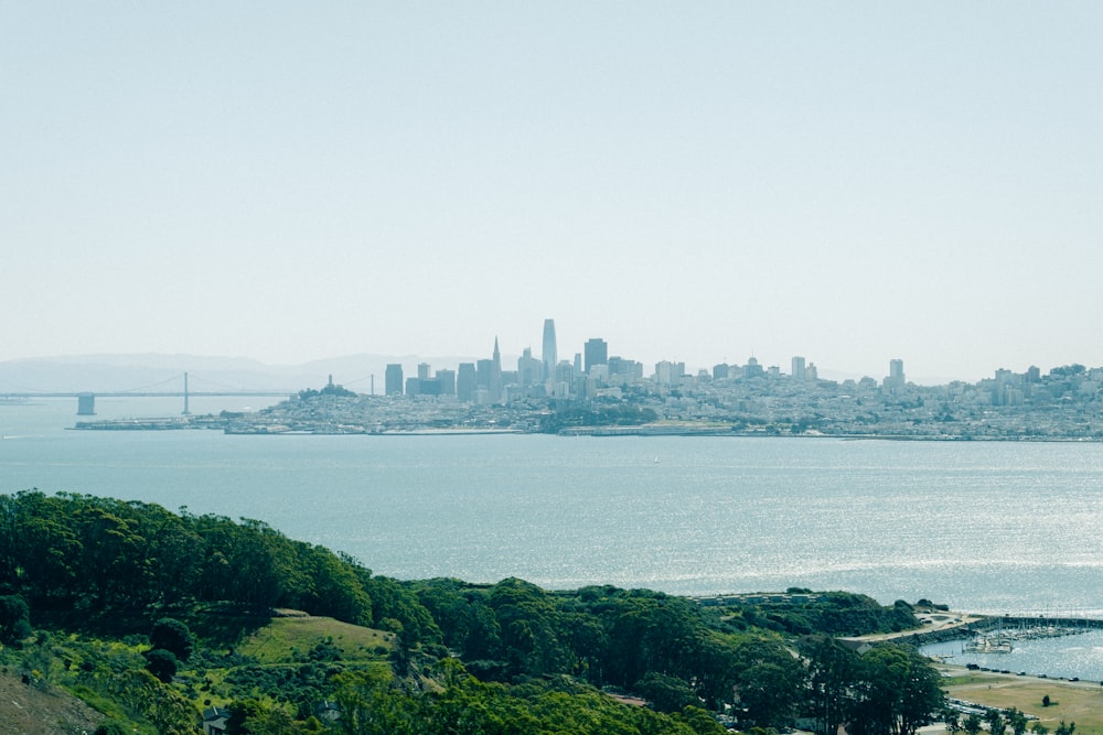 a large body of water with a city in the background