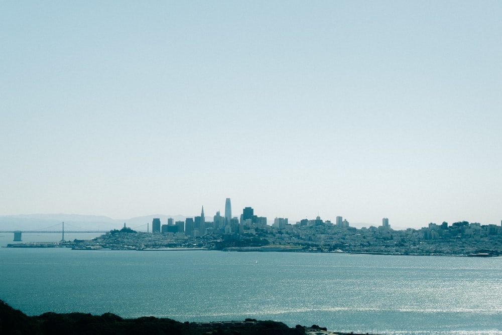 a large body of water with a city in the background