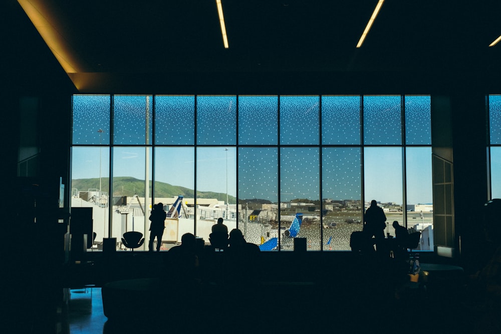 a group of people standing in front of a window