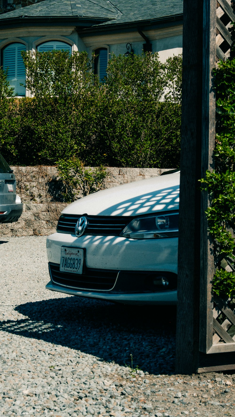 a white car parked in front of a house