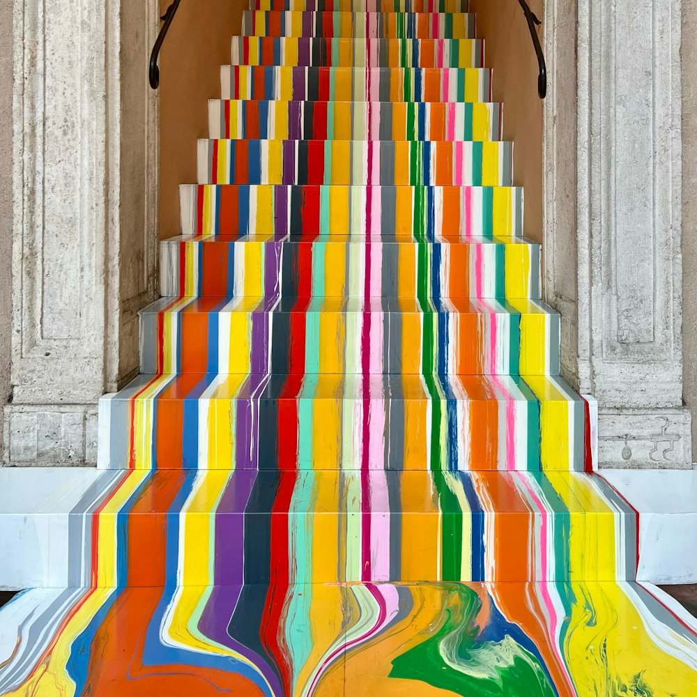 a colorful staircase painted with multicolored stripes