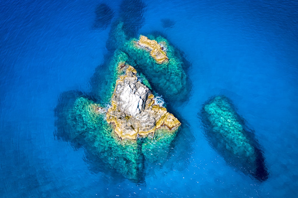 an aerial view of a rock formation in the ocean