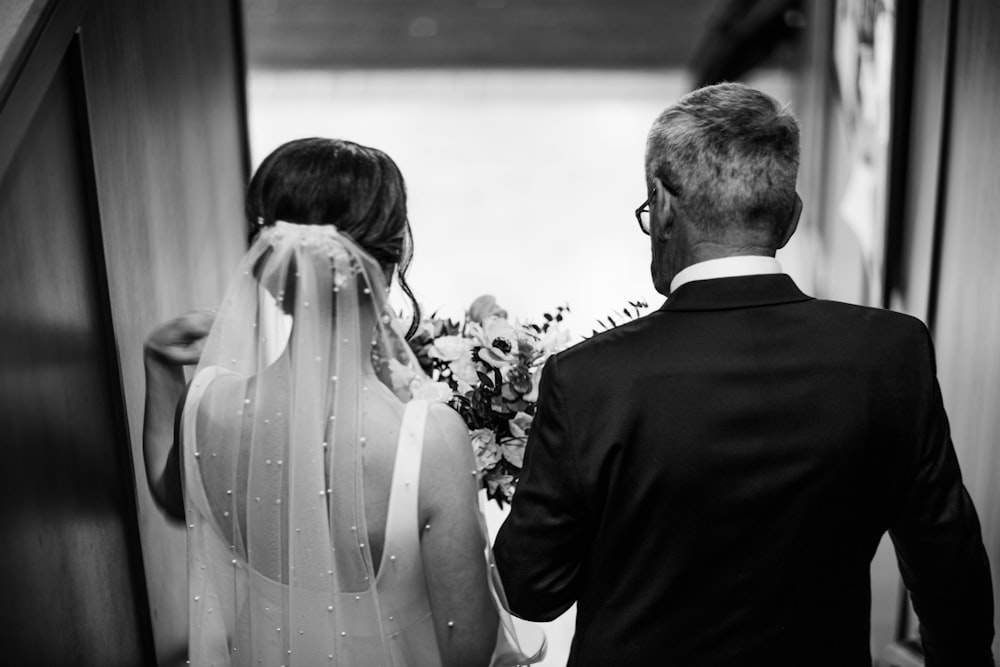 a man and a woman walking down a hallway