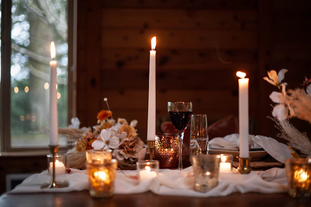 A cozy candlelit dinner setting for two, with soft warm lighting.