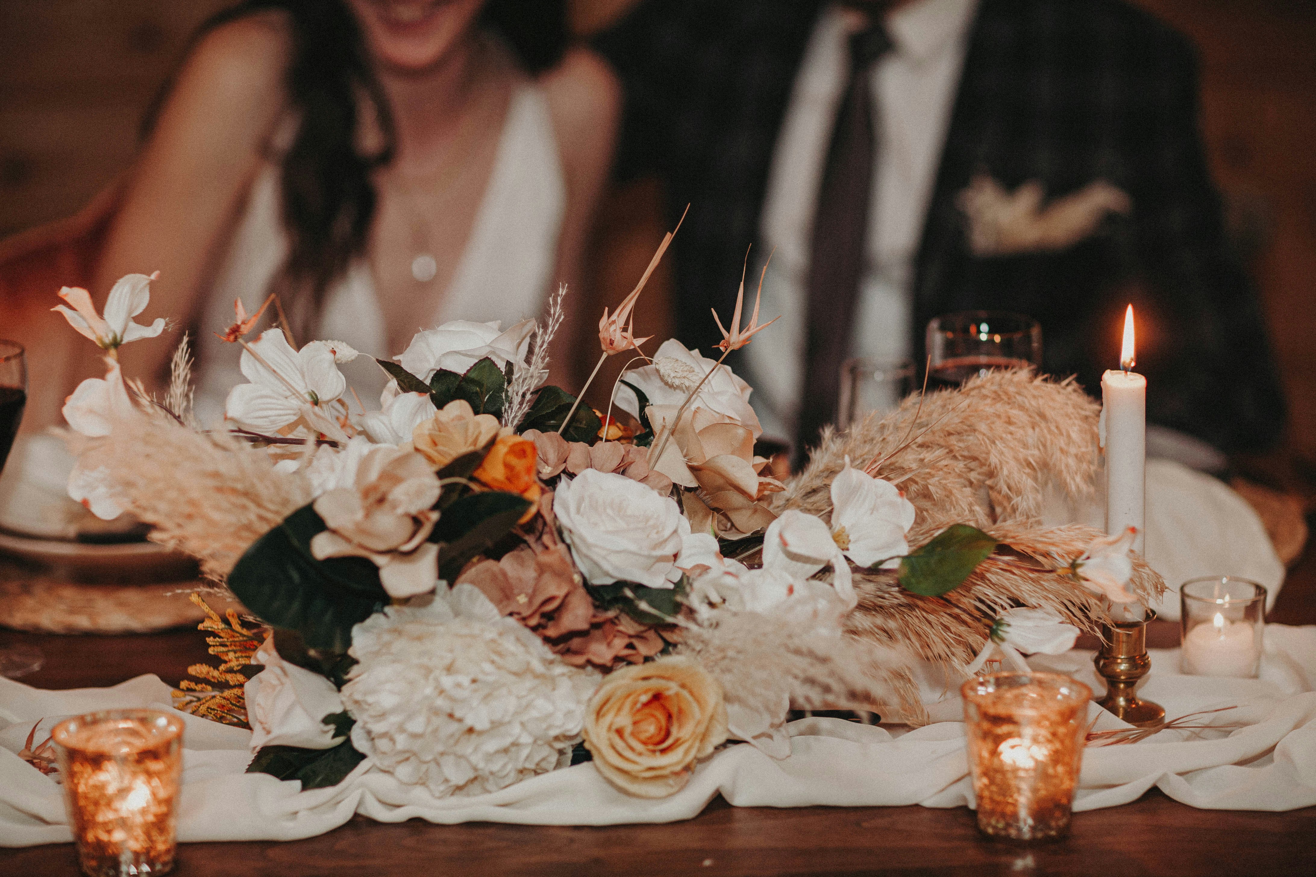 Candlelit table with a flower bouquet