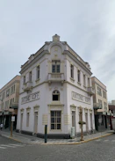 a white building with a clock on the front of it