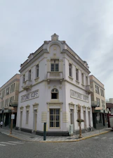 a white building with a clock on the front of it