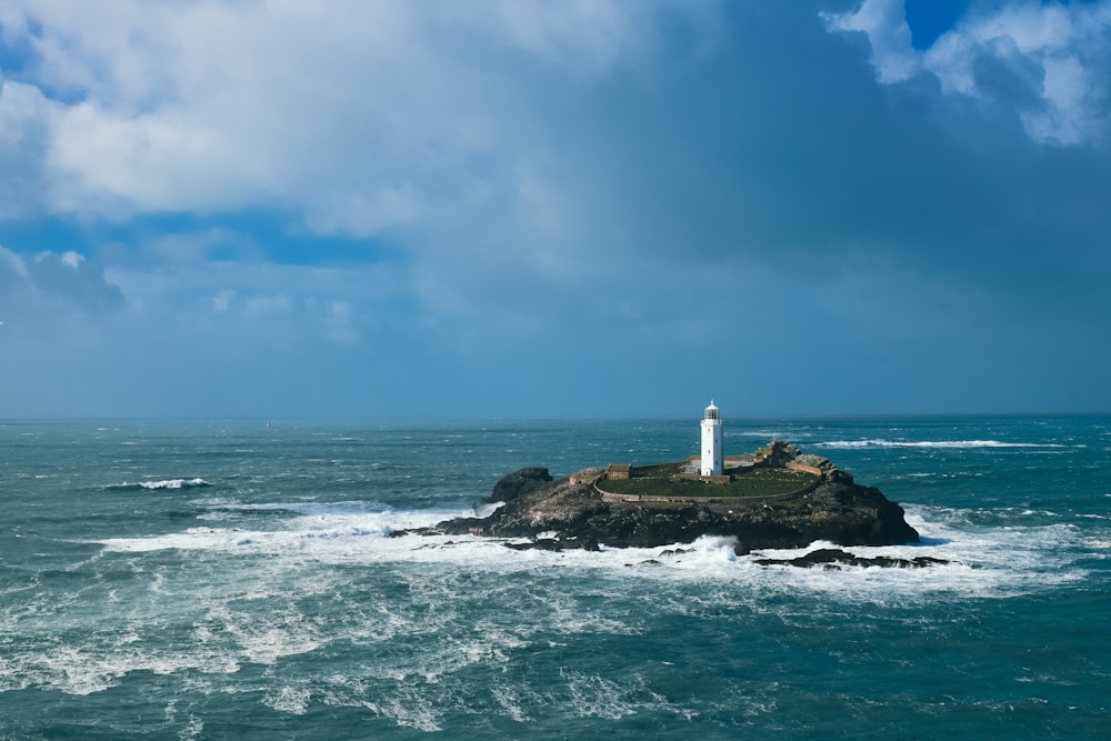 a lighthouse on an island in the middle of the ocean