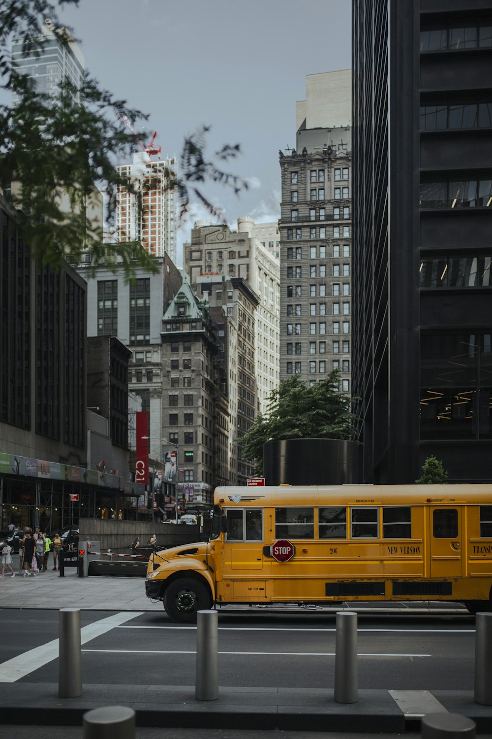 a yellow school bus driving down a city street