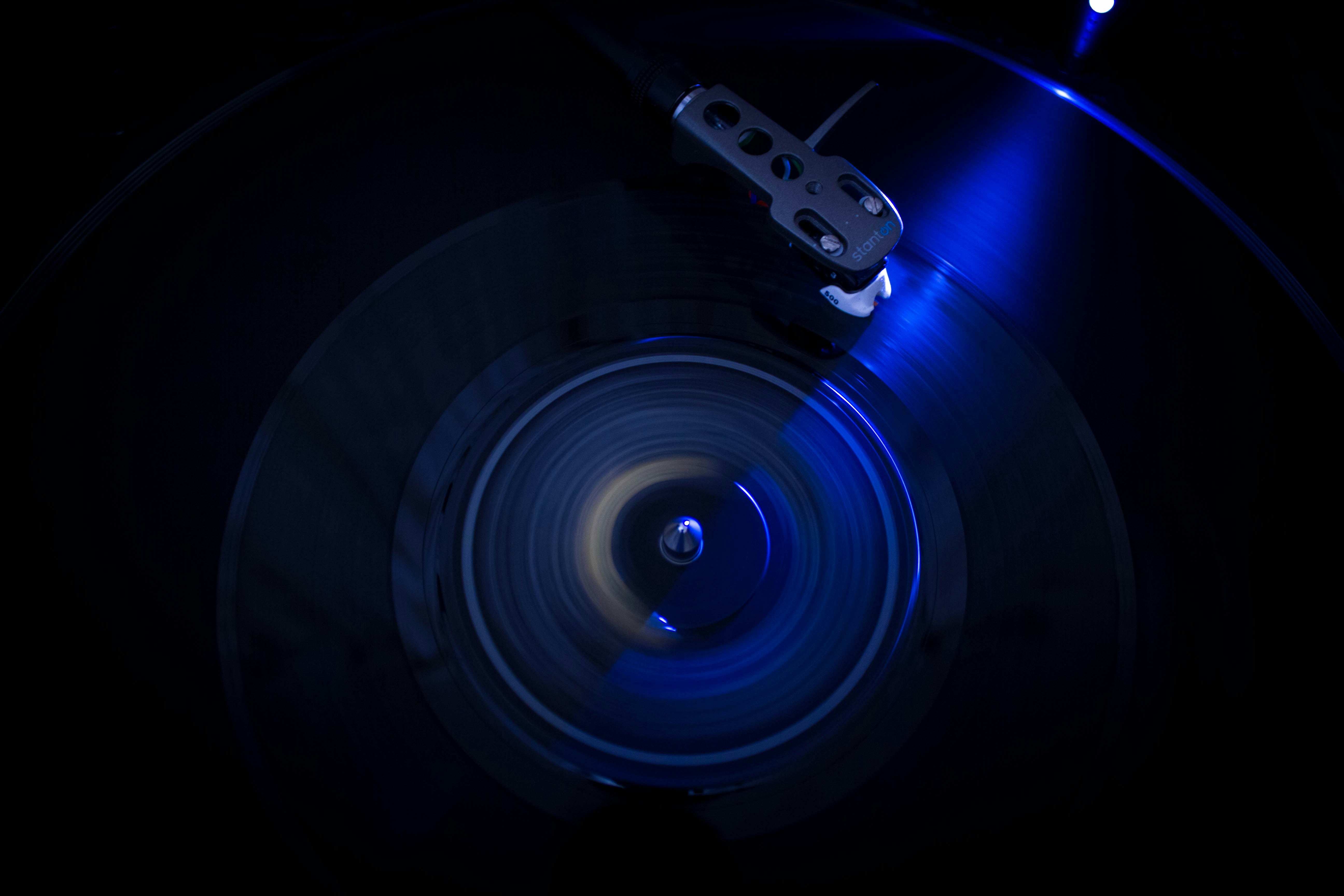 a close up of a record with a blue light