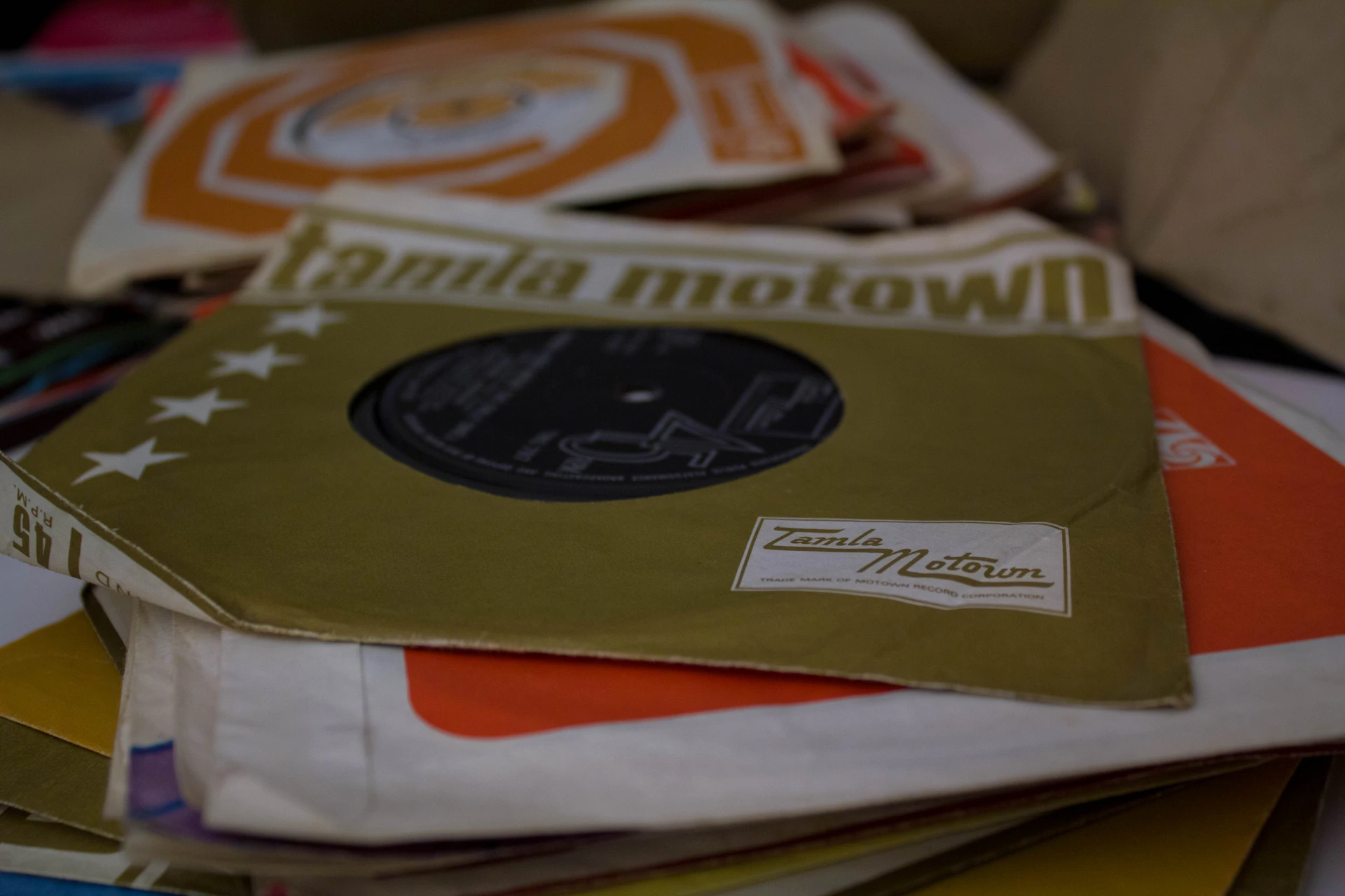 a pile of records sitting on top of a table