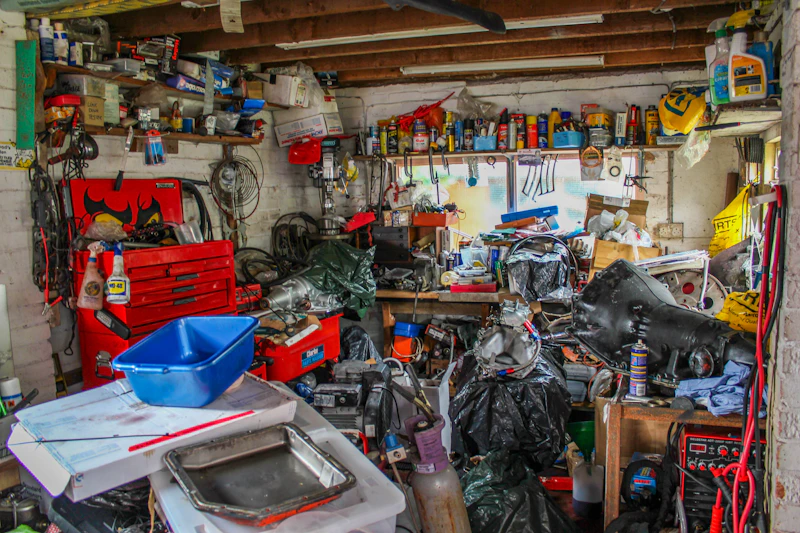 Workshop crammed wall-to-wall with tools, paint cans and spare parts