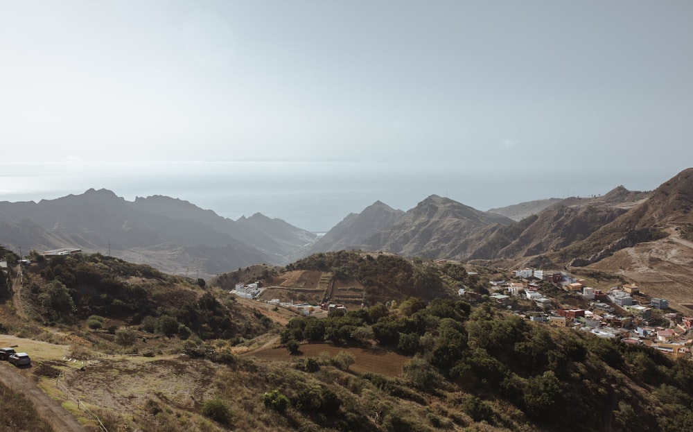 a scenic view of a town and mountains