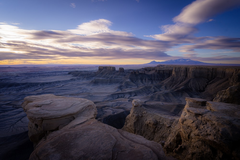 a view of a mountain range with a sunset in the background