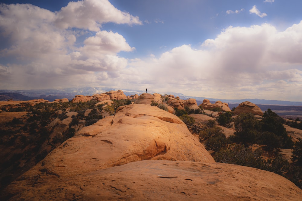 a person standing on top of a large rock