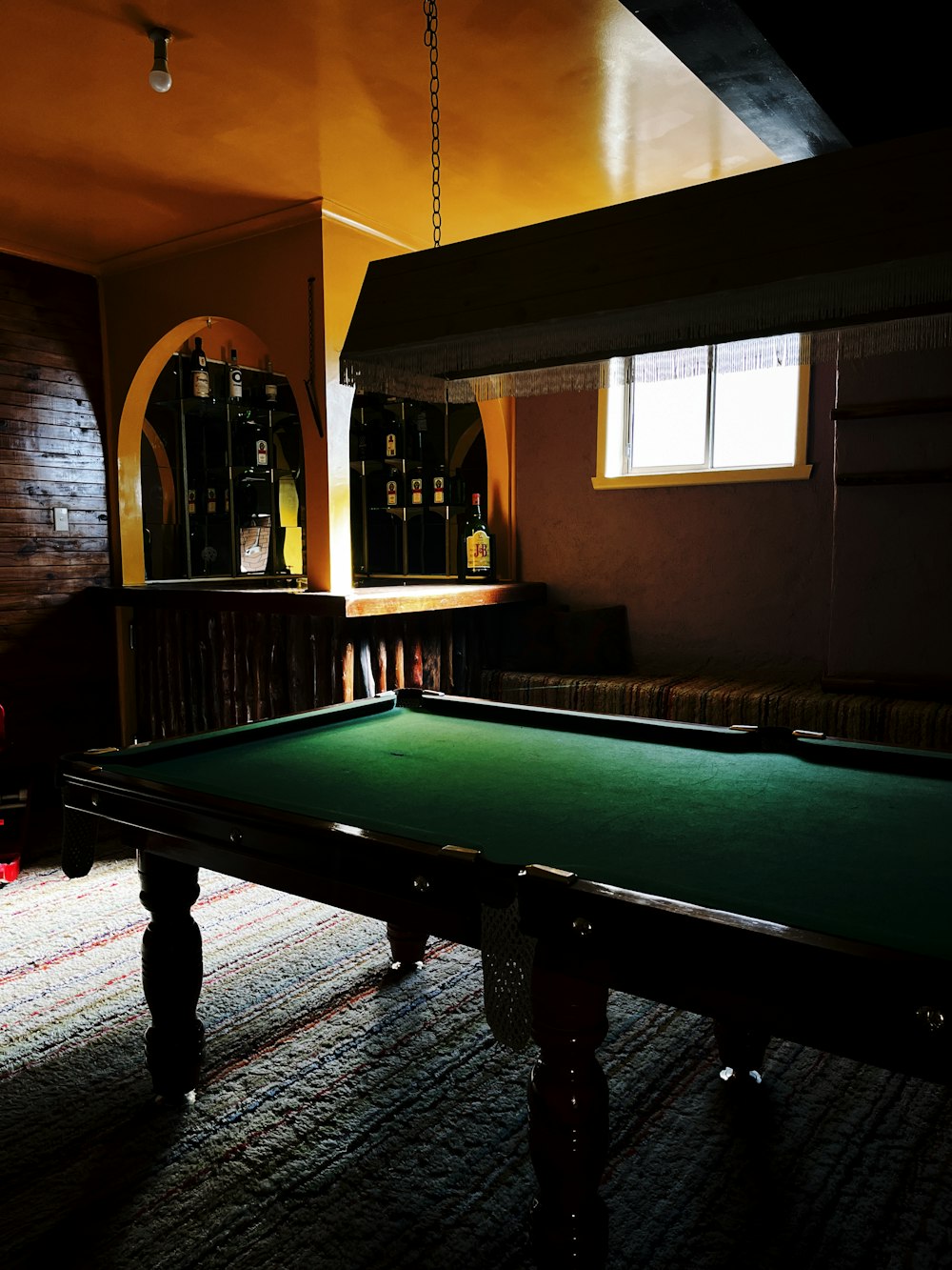 a pool table in a dimly lit room