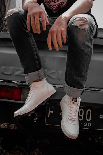 a man sitting on the back of a truck
