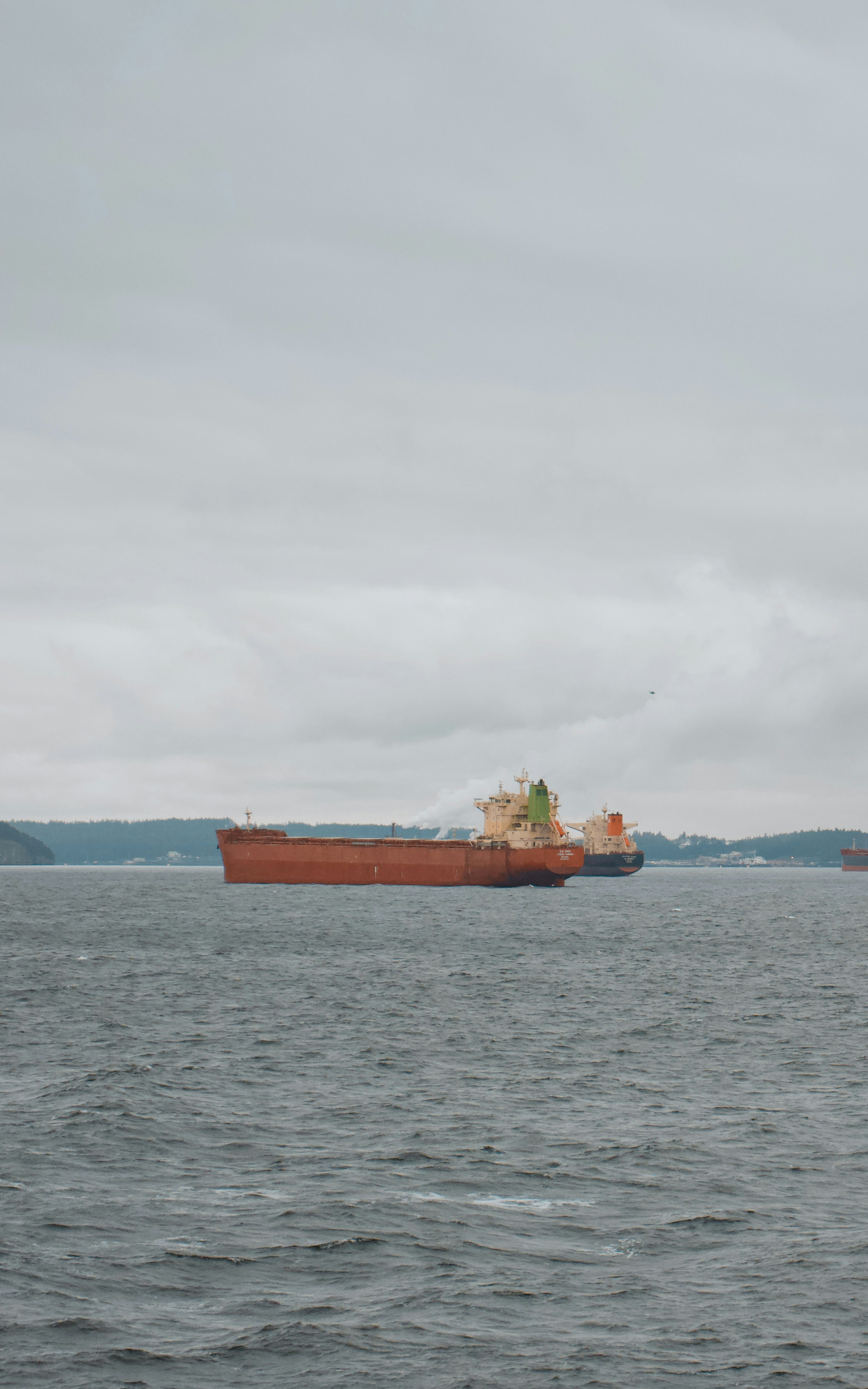 a large cargo ship floating on top of a large body of water