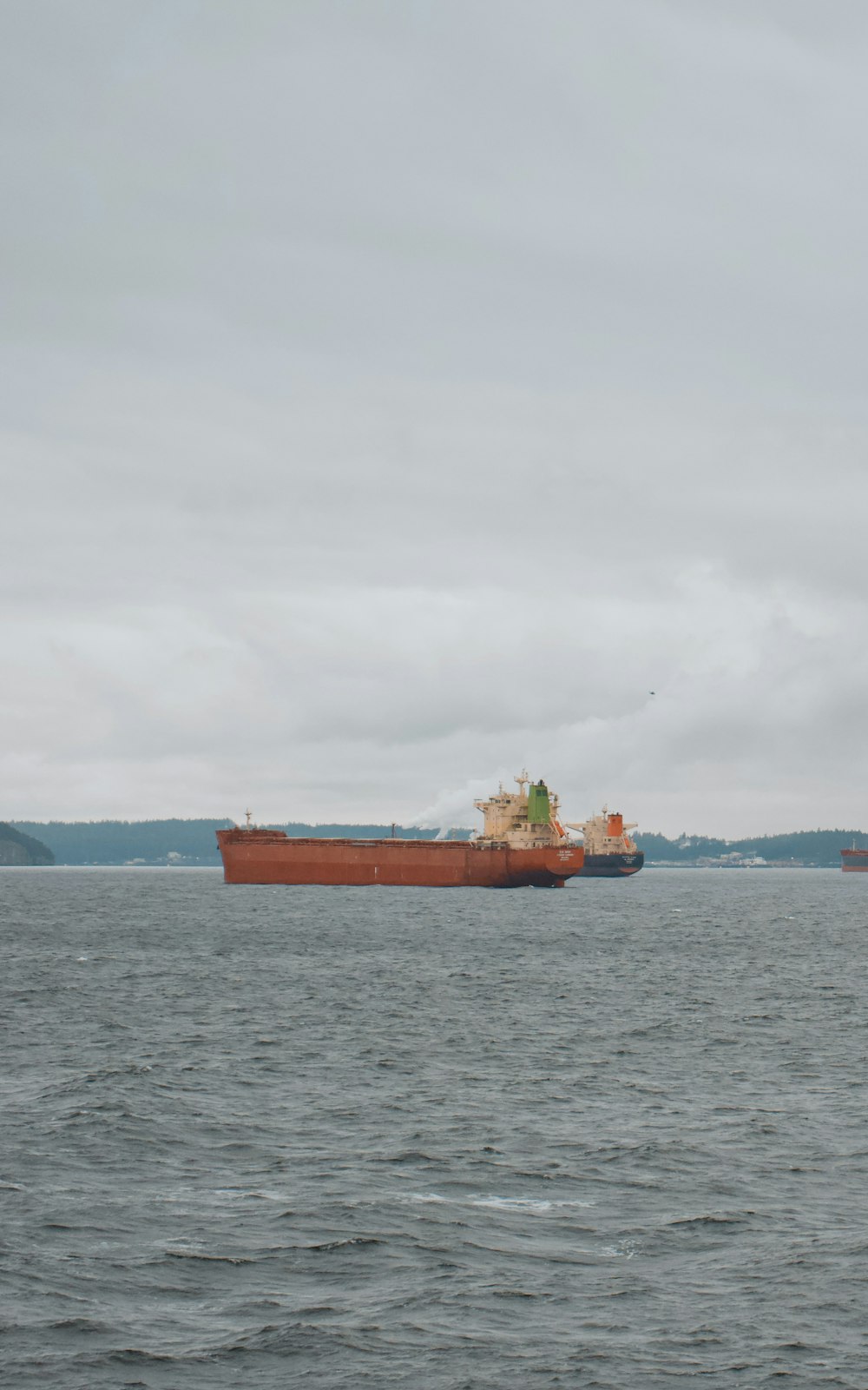 a large cargo ship floating on top of a large body of water