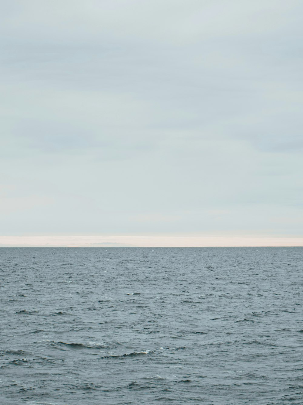 a large body of water sitting under a cloudy sky