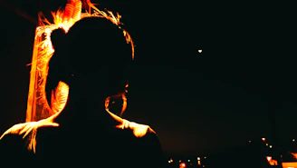 A shadowy figure standing beneath a swirling indigo nebula, illuminated by soft golden light.