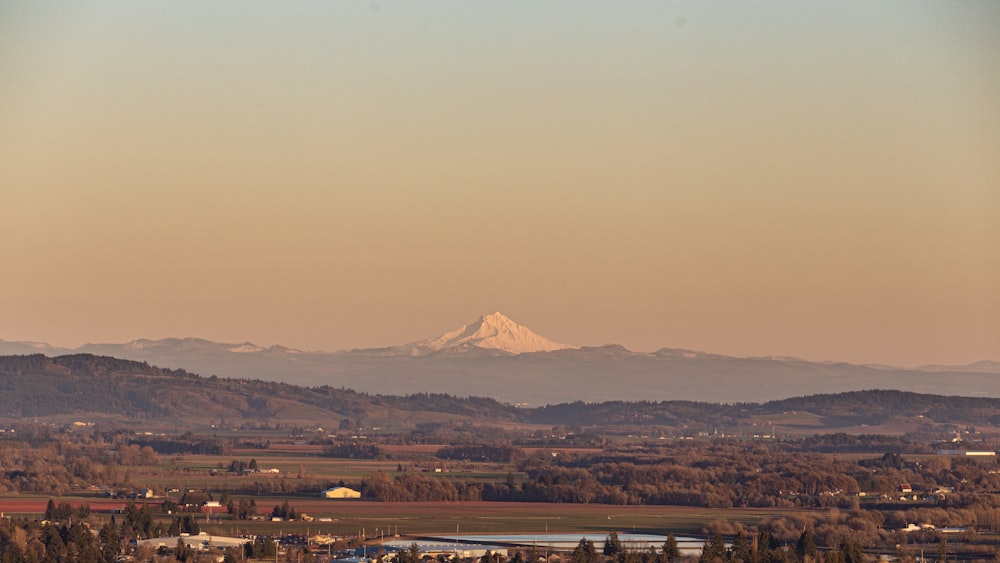 a view of a mountain range with a lake in the foreground