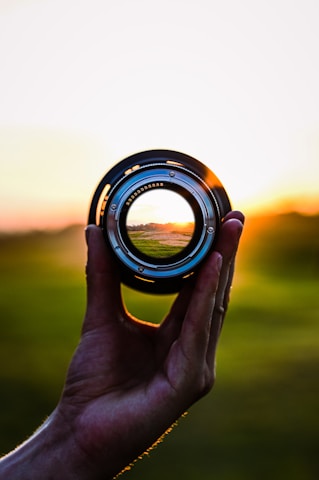 Tarun J Singh behind the camera, focused on framing a scenic landscape at golden hour.
