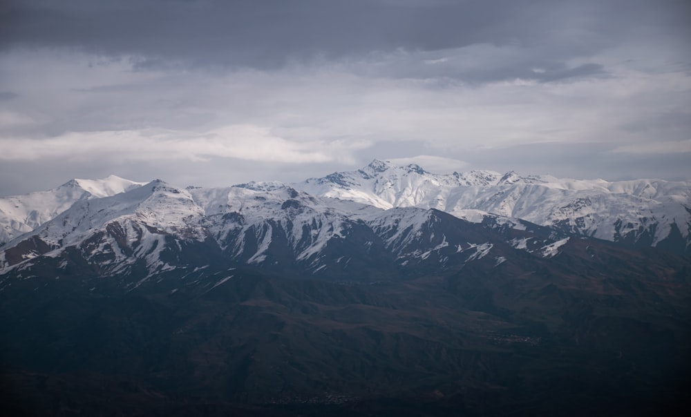 a view of a snowy mountain range from an airplane