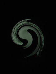 a black and white photo of a swirl in the dark