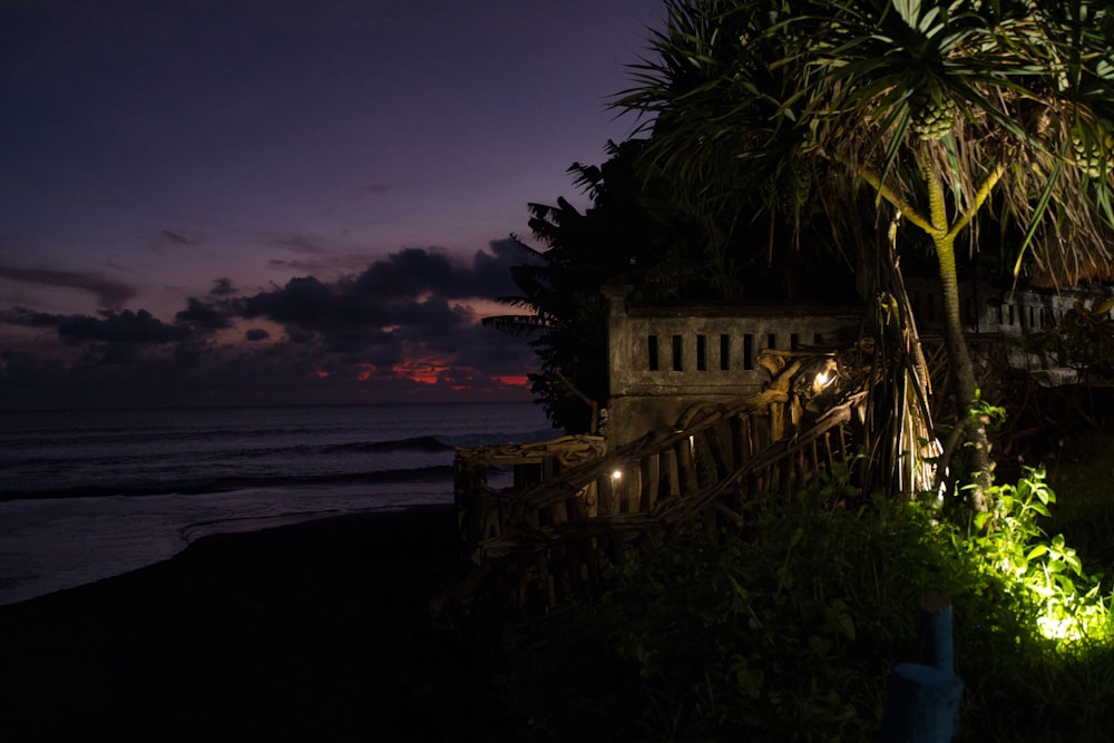 a night time view of the ocean and a house