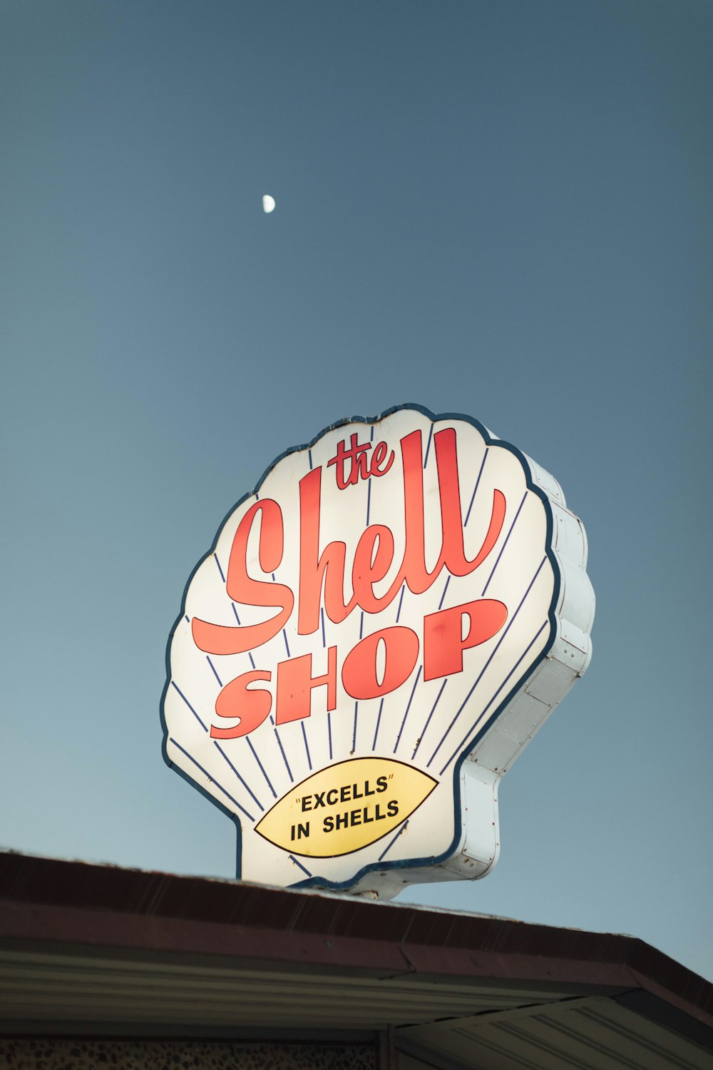 a shell shop sign on top of a building