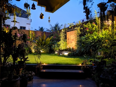 Peaceful outdoor garden area with sand and twilight sky in background.