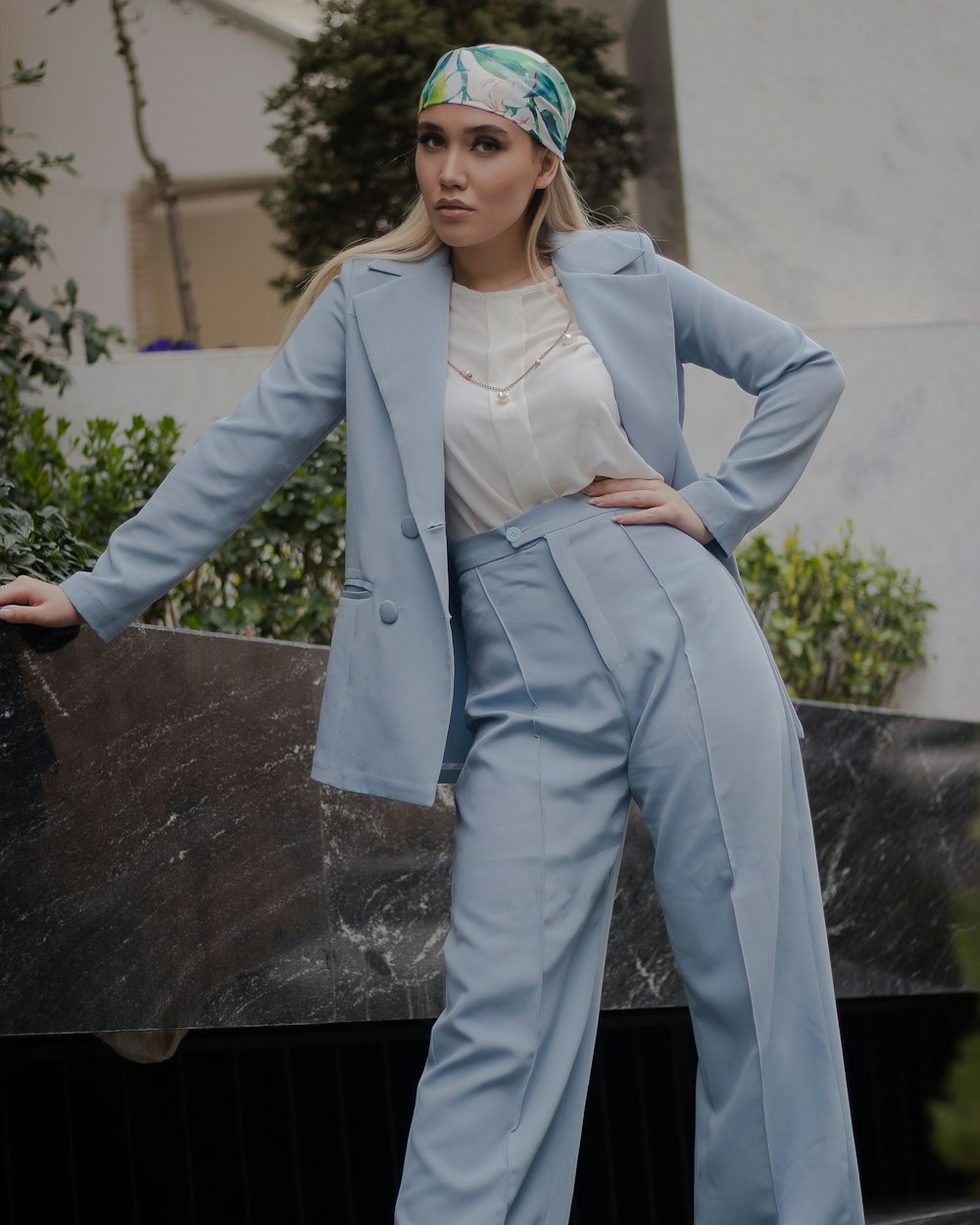 a woman wearing a blue suit and headband