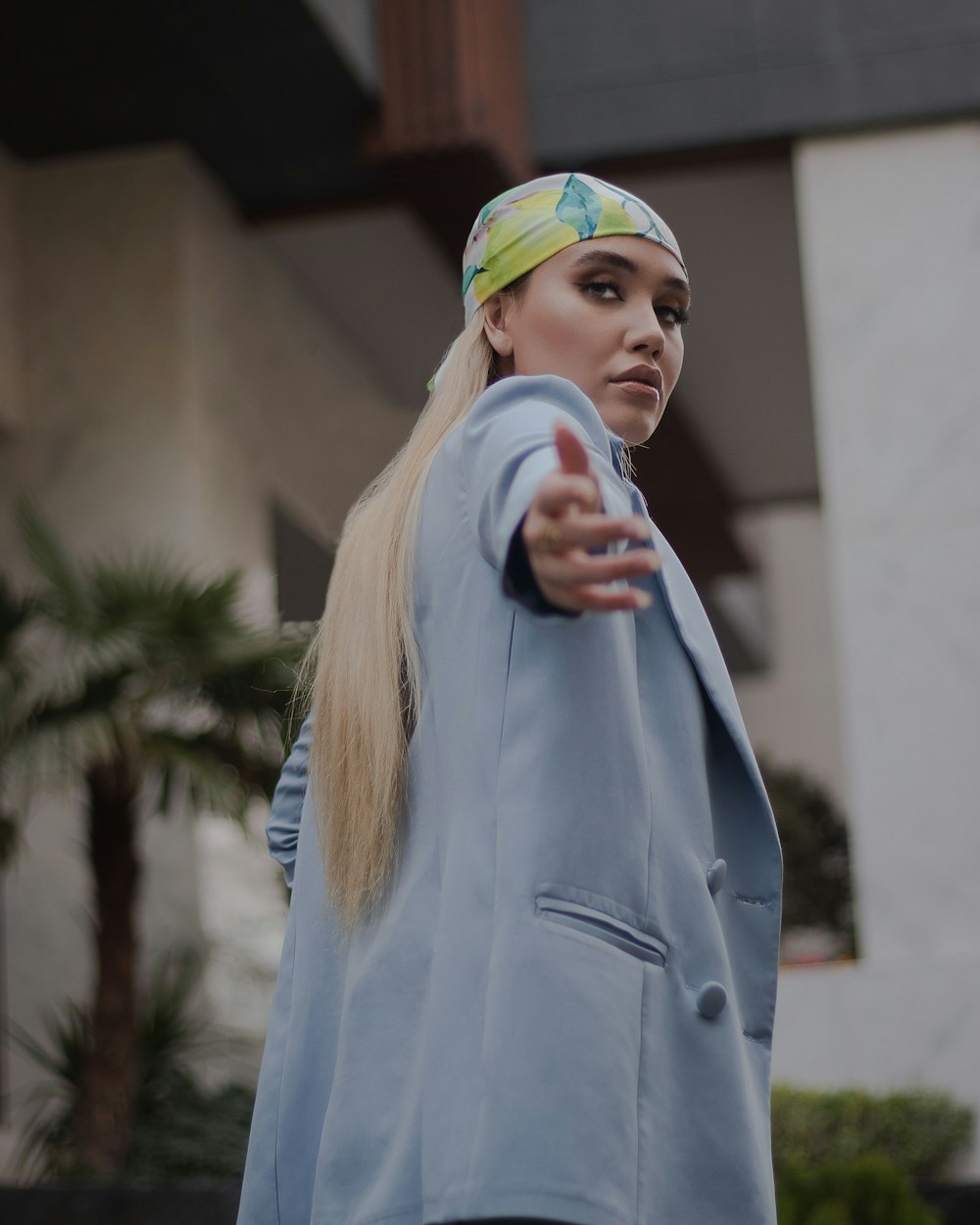 a woman wearing a blue jacket and a yellow headband