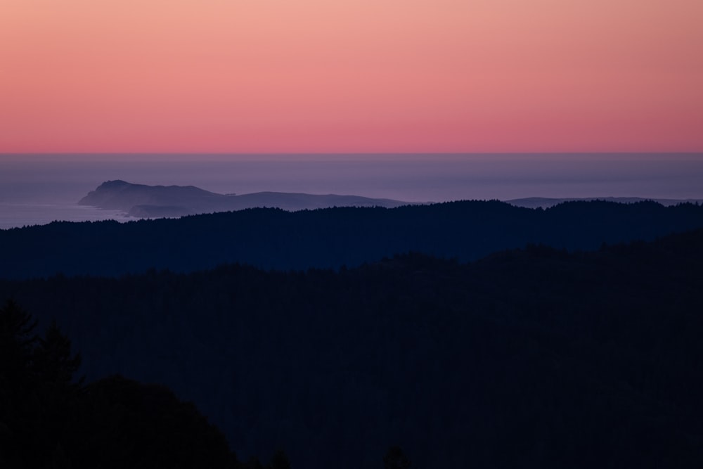 a view of a sunset over a mountain range