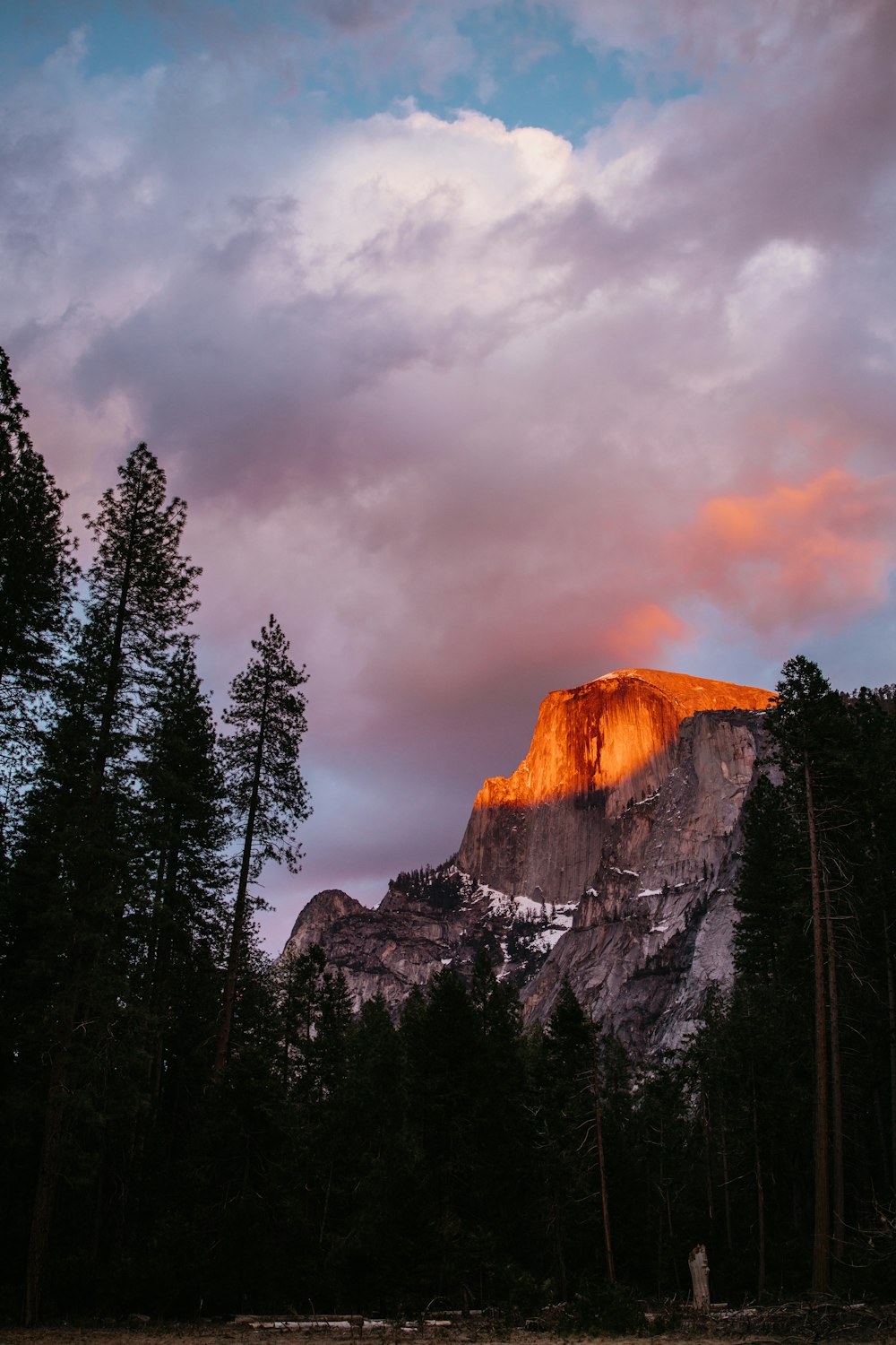 a mountain with a sunset in the background